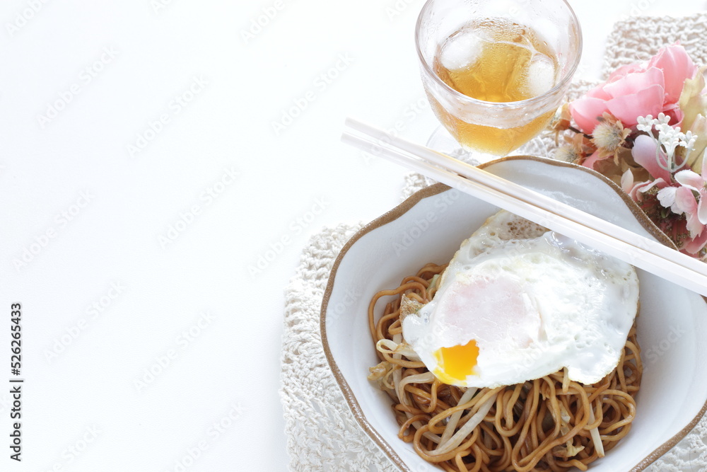 Japanese style fried noodles with fried egg on top for comfort food image Japanese style fried noodles with fried egg on top for comfort food image