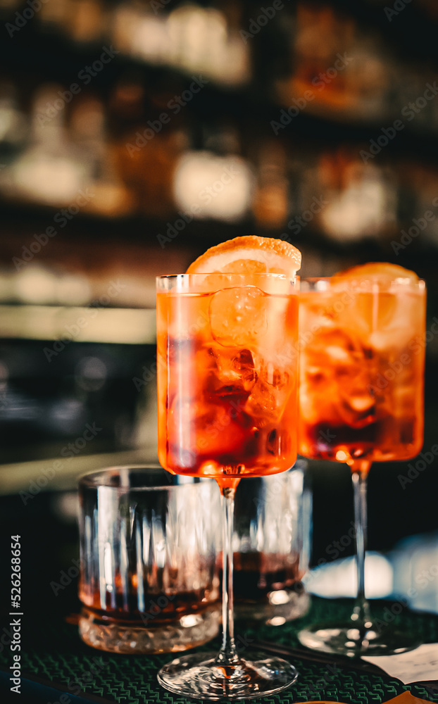 Aperol Spritz Cocktail in glass on bar counter Aperol Spritz Cocktail in glass on bar counter
