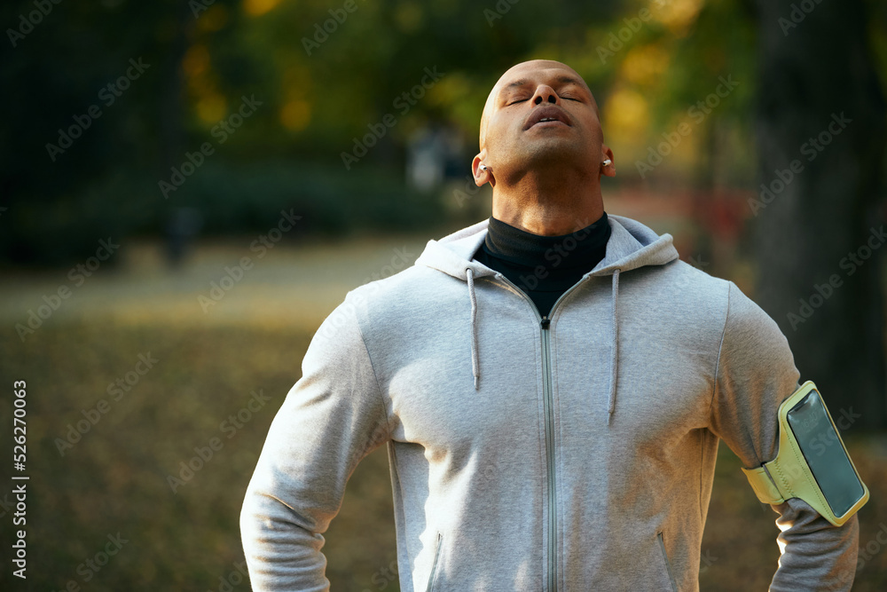 Young black athlete working out in park on autumn day. Young black athlete working out in park on autumn day.