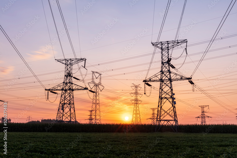 In the evening, the silhouette of high voltage towers