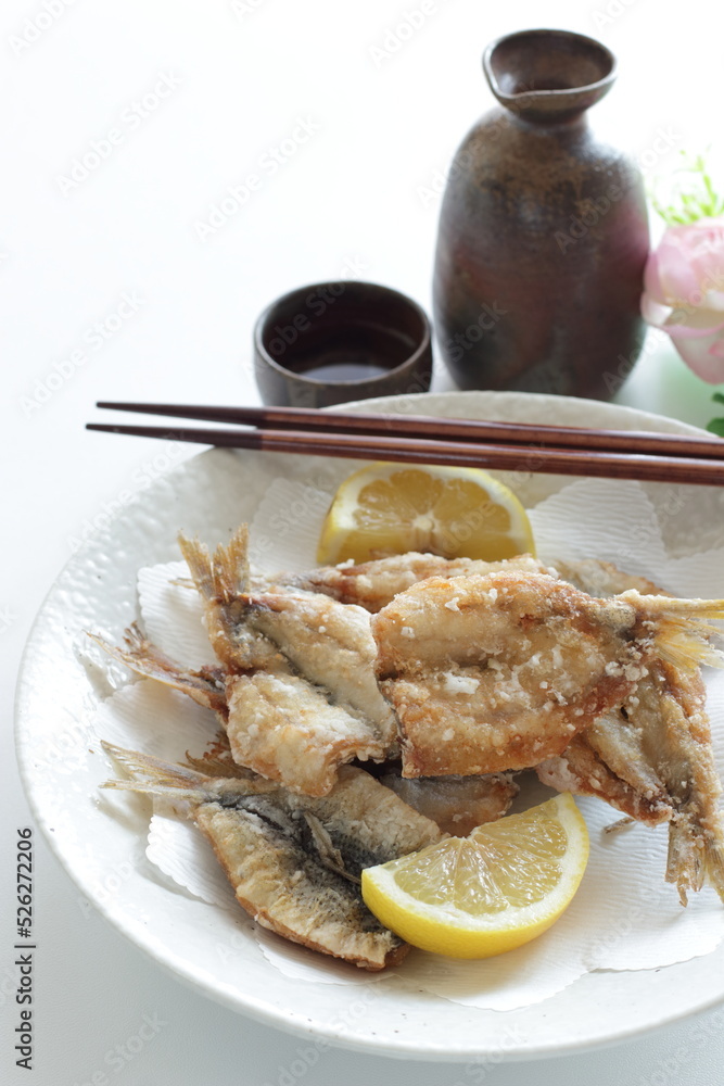 Japanese food, deep fried spotted sardine fish served with Saki Japanese food, deep fried spotted sardine fish served with Saki