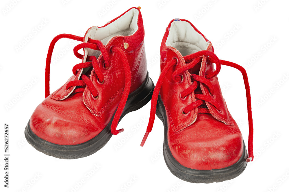 Worn out kiddie-size red lace-ups. Children's shoes with laces. Old ankle boots for small kid. Worn out kiddie-size red lace-ups. Children's shoes with laces. Old ankle boots for small kid.