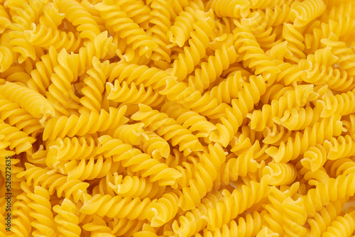 Close-up of raw pasta, texture or background Fusilli. Raw and Dry Macaroni. Italian Culture.