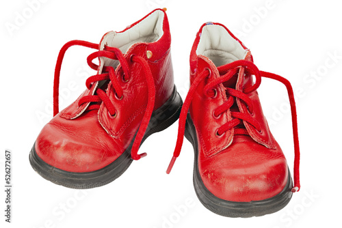 Worn out kiddie-size red lace-ups. Children's shoes with laces. Old ankle boots for small kid.