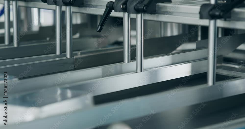 Production of foil food trays at the factory. Pressing machine on ...