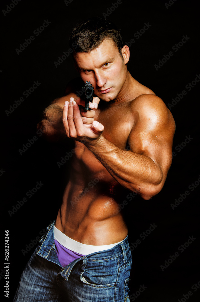 Young sexy guy posing in the studio. A man with a beautiful athletic body.