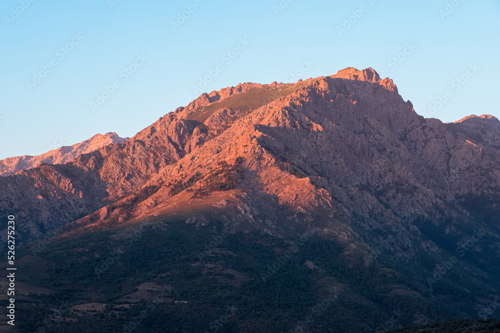 Morning sunlight on the craggy 2389 metre high mountain peak of Monte Padro in Corsica