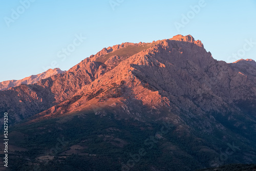 Morning sunlight on the craggy 2389 metre high mountain peak of Monte Padro in Corsica