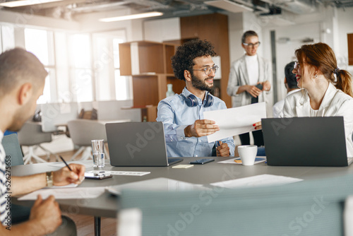 Busy coworkers cooperating and working together at office meeting, teamwork concept