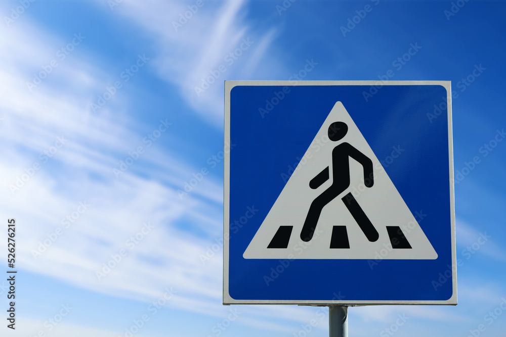 Post with Pedestrian Crossing traffic sign in city on sunny day Post with Pedestrian Crossing traffic sign in city on sunny day
