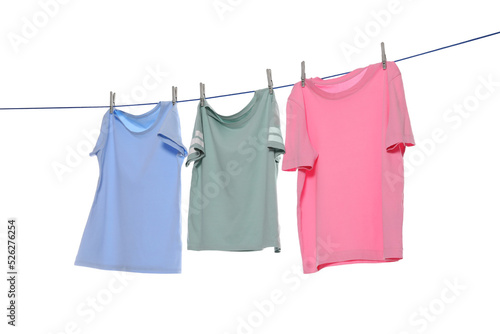 Different clothes drying on washing line against white background photo