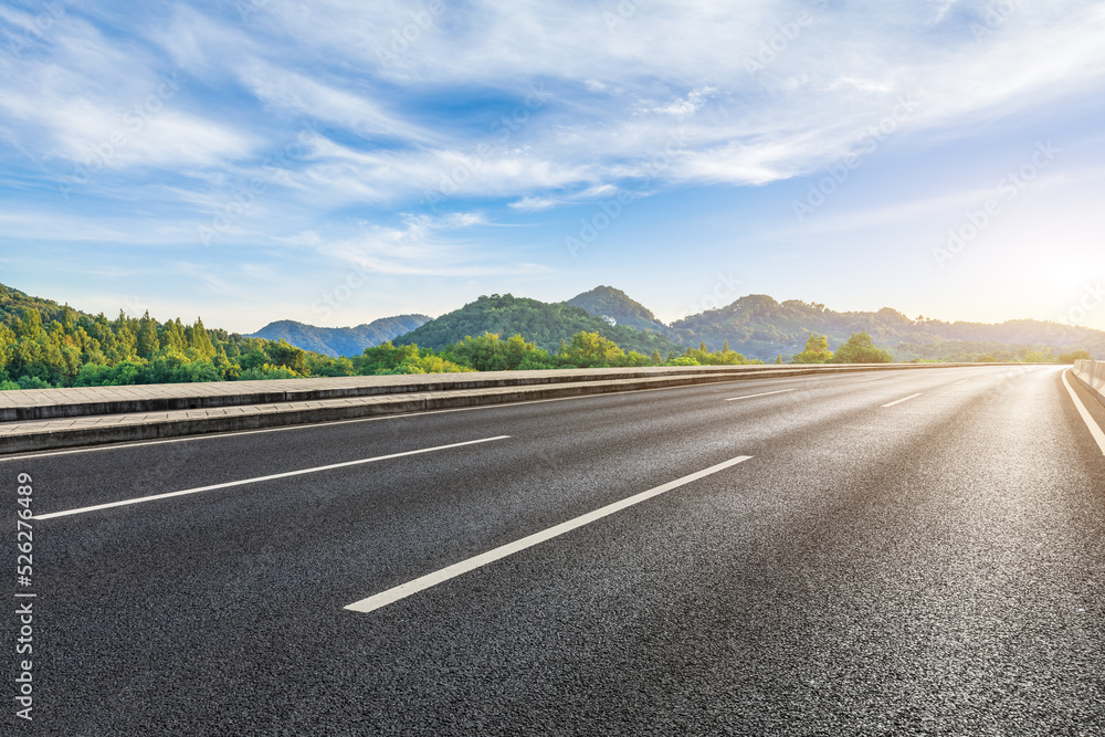 Asphalt road and green forest with mountain nature landscape Asphalt road and green forest with mountain nature landscape