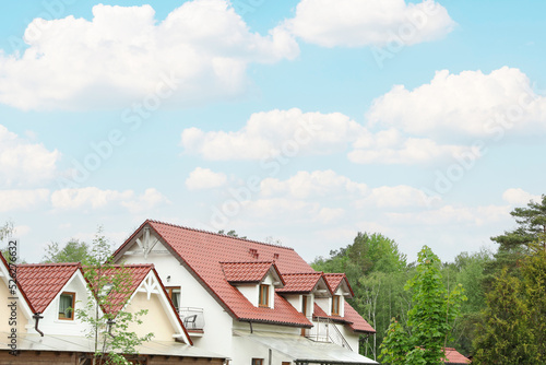 Wallpaper Mural Modern buildings with red roofs near forest on spring day Torontodigital.ca
