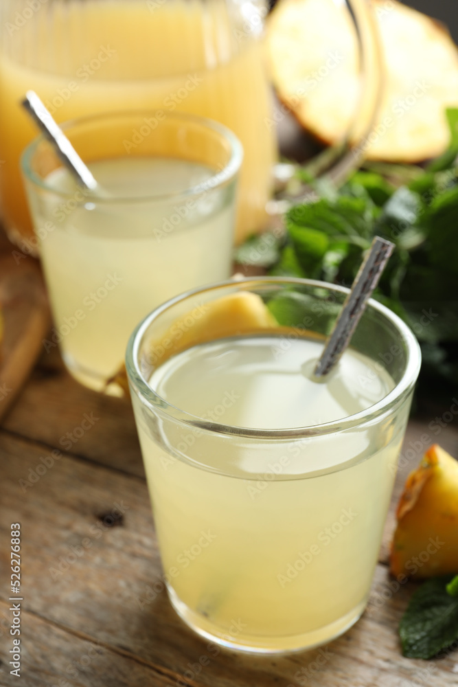 Delicious pineapple juice and fresh fruit on wooden table Delicious pineapple juice and fresh fruit on wooden table