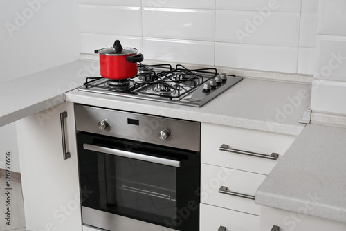 Red pot on gas stove in kitchen