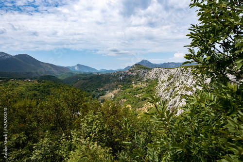 Amazing, mountain landscape of Croatian rocky hills covered in forest and vegetation with Cetina river passing through the canyon in the valley
