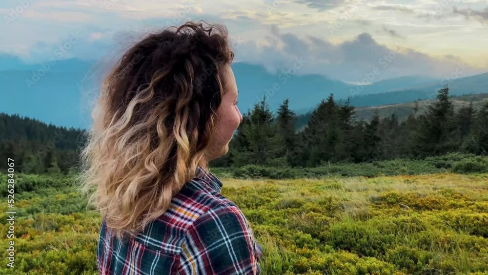 beautiful curly girl looking at the mountains against the backdrop of the Carpathian and forests at sunset blue sky tourism travel outdoor recreation vacation walks weekend back view without face beautiful curly girl looking at the mountains against the backdrop of the Carpathian and forests at sunset blue sky tourism travel outdoor recreation vacation walks weekend back view without face