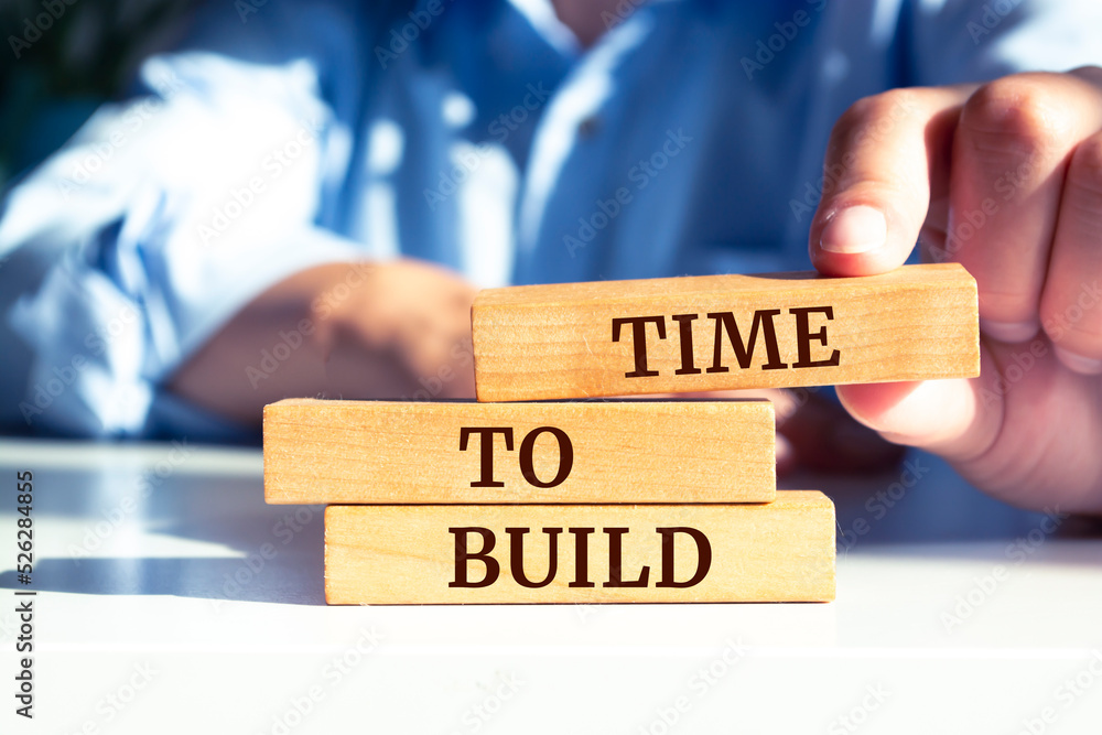 Wooden blocks with words 'time to build'. Business concept