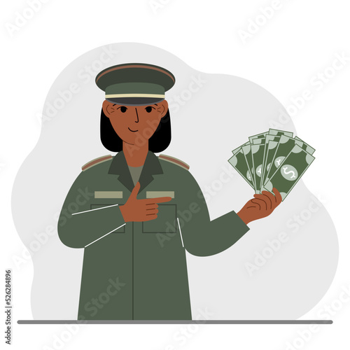 Military woman holds a lot of money in his hand. The concept of payment for military service or service in the army under a contract.