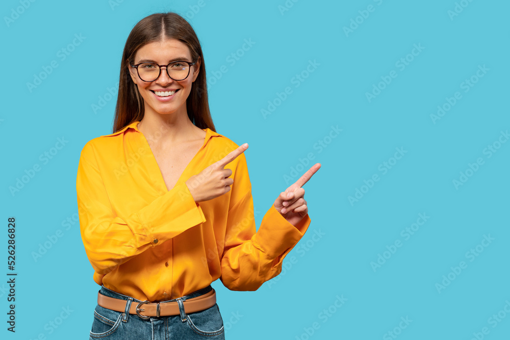 Young woman pointing with index fingers to the side, showing copy space for offer Young woman pointing with index fingers to the side, showing copy space for offer