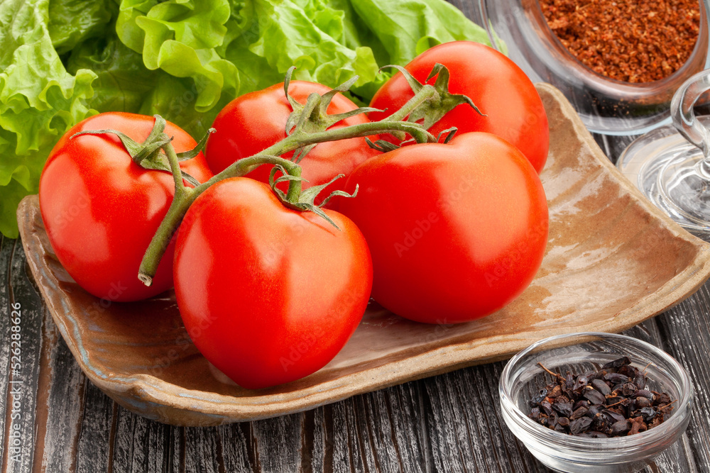 tomato on a plate on wood background tomato on a plate on wood background