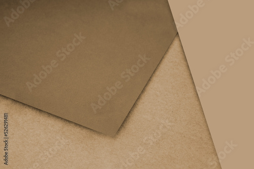 Plain and Textured tan brown papers randomly laying to form M like pattern and triangle for creative cover design idea