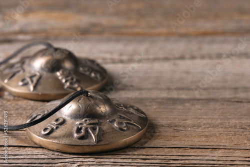 Close up of tibetan cymbals on a wooden table with copyspace