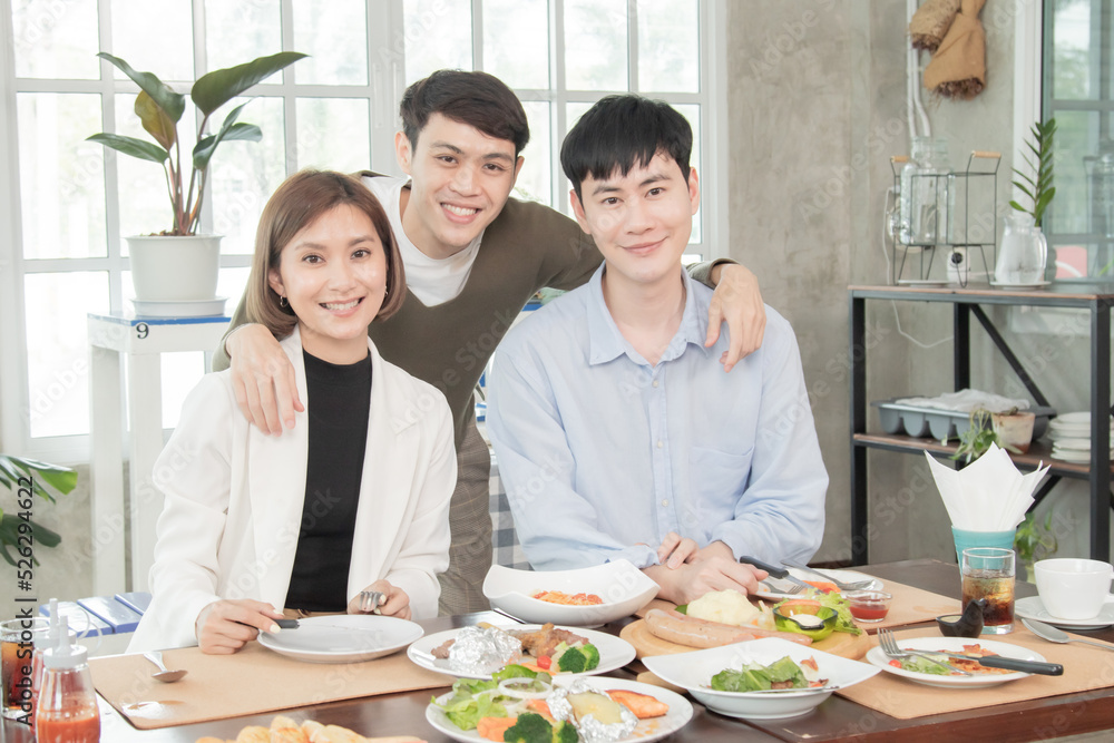 Young Asian colleague worker spent lunchtime together near office, group of friends dinner or luncheon talk in restaurant and take pictures with happy, young people in official dress lifestyle