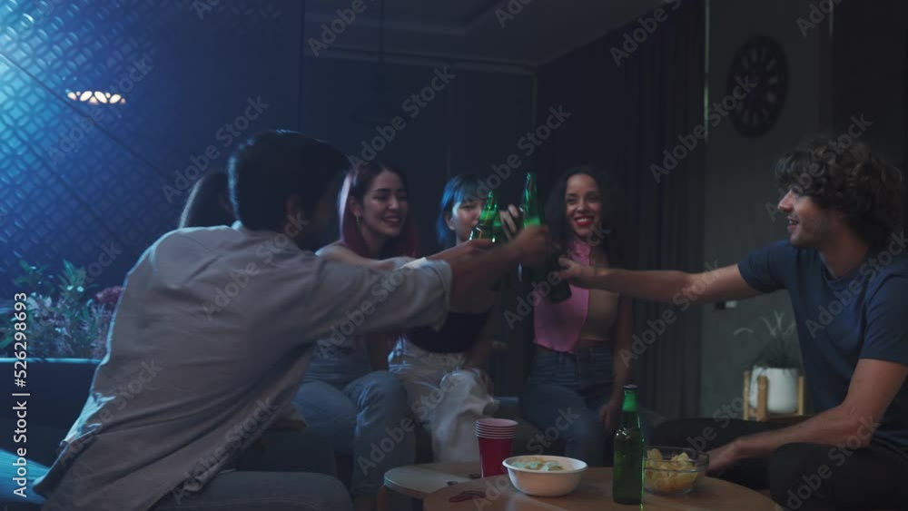 Group of Diverse people clinking beer bottle on night party. Group of Diverse people clinking beer bottle on night party.