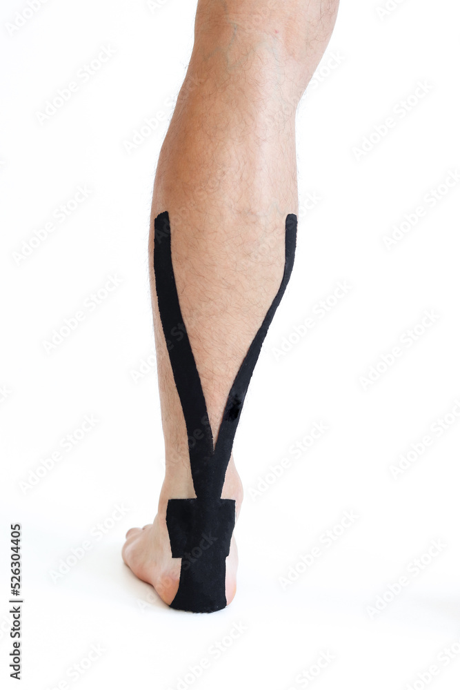 Kinesiology taping treatment with black tape on male patient injured