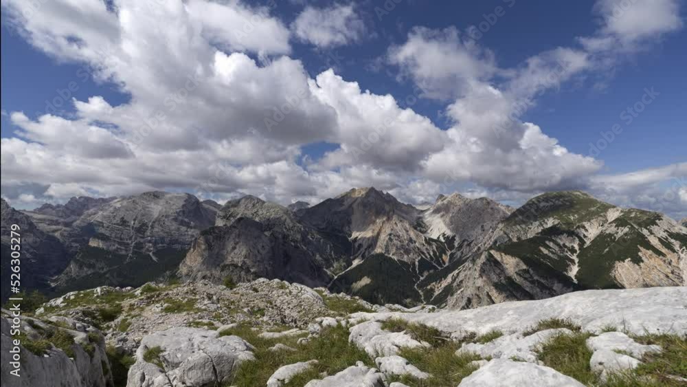 White clouds in a blue sky over mountains in the Dolomites, Italy White clouds in a blue sky over mountains in the Dolomites, Italy