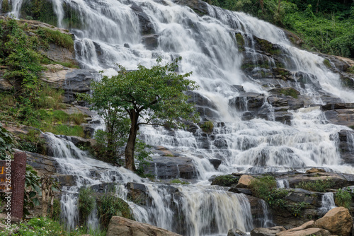 The waterfall was flowing down from the rocky cliff. At Mae Ya Waterfall, Chom Thong District, Chiang Mai Province, Thailand