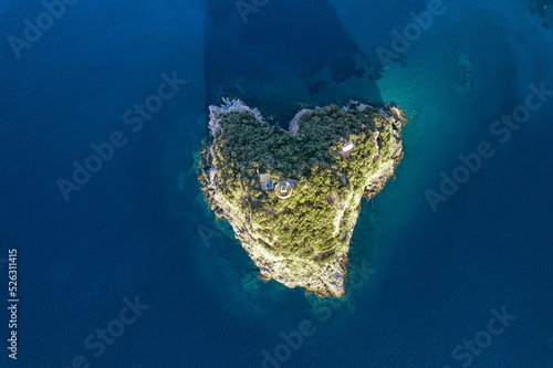 Aerial view from above of the beautiful heart-shaped natural island in the Mediterranean Sea along the coast of Liguria, Italy