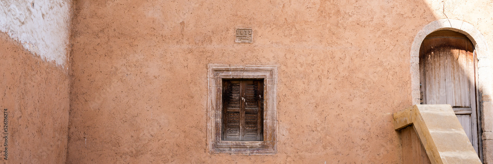Old wooden window stone wall house Morocco 