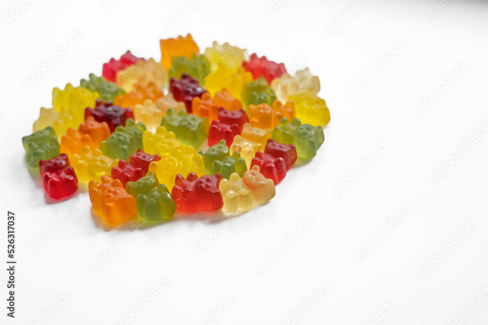 close up hight angle view of a pile of colorful gummy bears on a light background close up hight angle view of a pile of colorful gummy bears on a light background