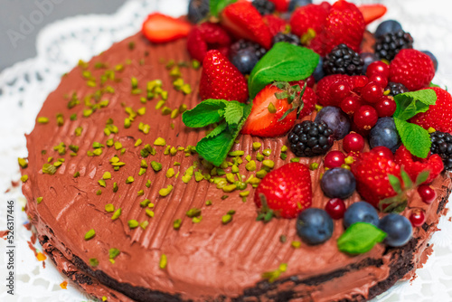 Delicious vegetarian chocolate cake with berries and pistachio 