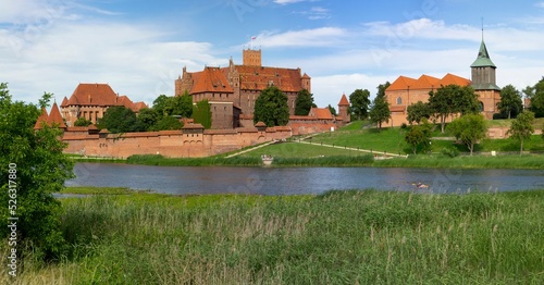 Malbork castle panorama with Nogat river and tourist photo