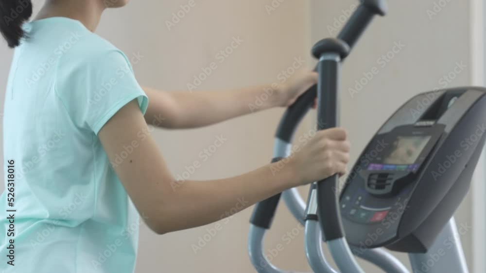Woman running on treadmill in Gym, Jogging, Warm up in the gym. Woman running on treadmill in Gym, Jogging, Warm up in the gym.