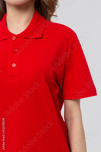 Close up Front view side of standing female model wearing plan red polo shirt