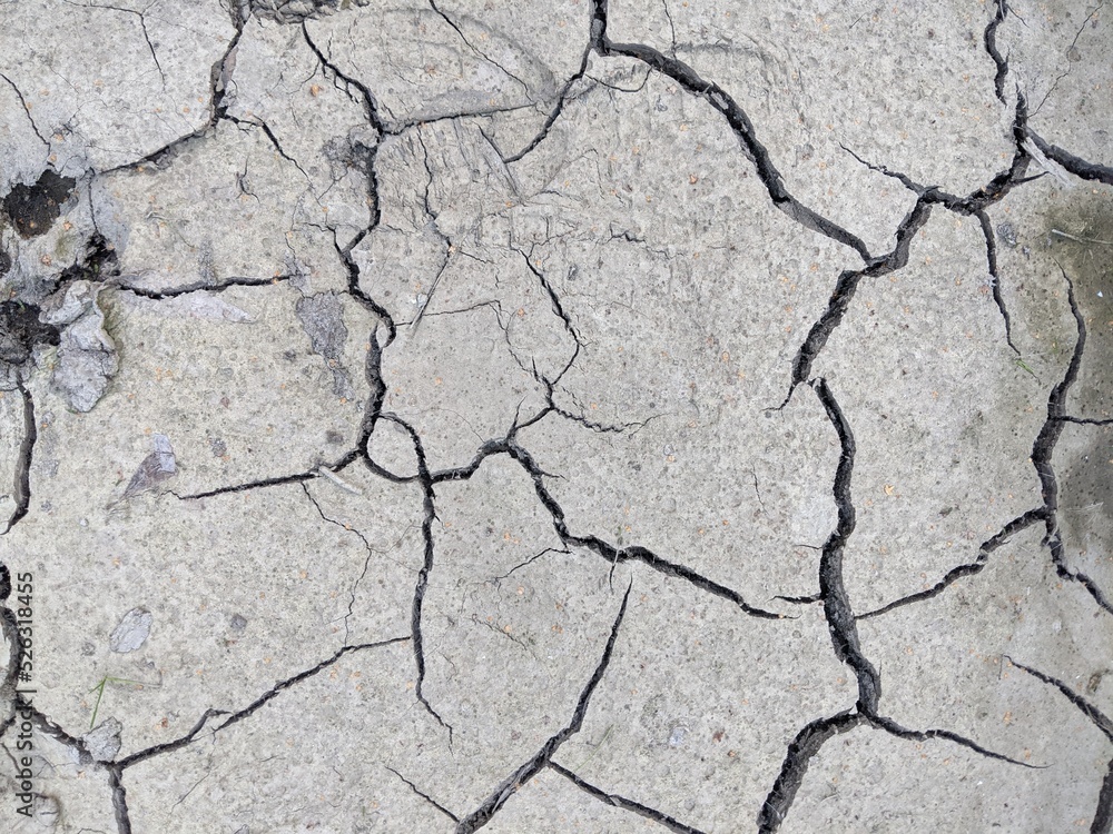 dry gray earth with cracks dry gray earth with cracks