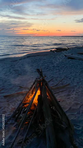 campfire on the beach at sunset overlooking the sea