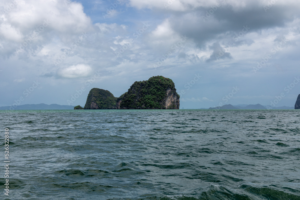 Phangna Bay with many Islands near Phuket Thailand. Lovely rock in the middle of the ocean surrounded by mountains Phangna Bay with many Islands near Phuket Thailand. Lovely rock in the middle of the ocean surrounded by mountains