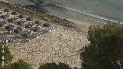 Sea and sunshades on beach at Cala Galdana from elevated position, Cala Galdana, Menorca, Balearic Islands photo