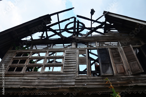 Exterior structure broken damaged of outdoor abandoned wooden antique building from old wood house fire at village in Bangkok, Thailand