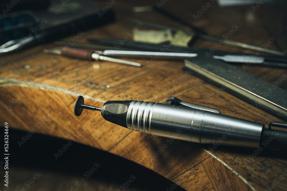 Front view of a set of various tools placed on a wooden desk in a workshop Front view of a set of various tools placed on a wooden desk in a workshop