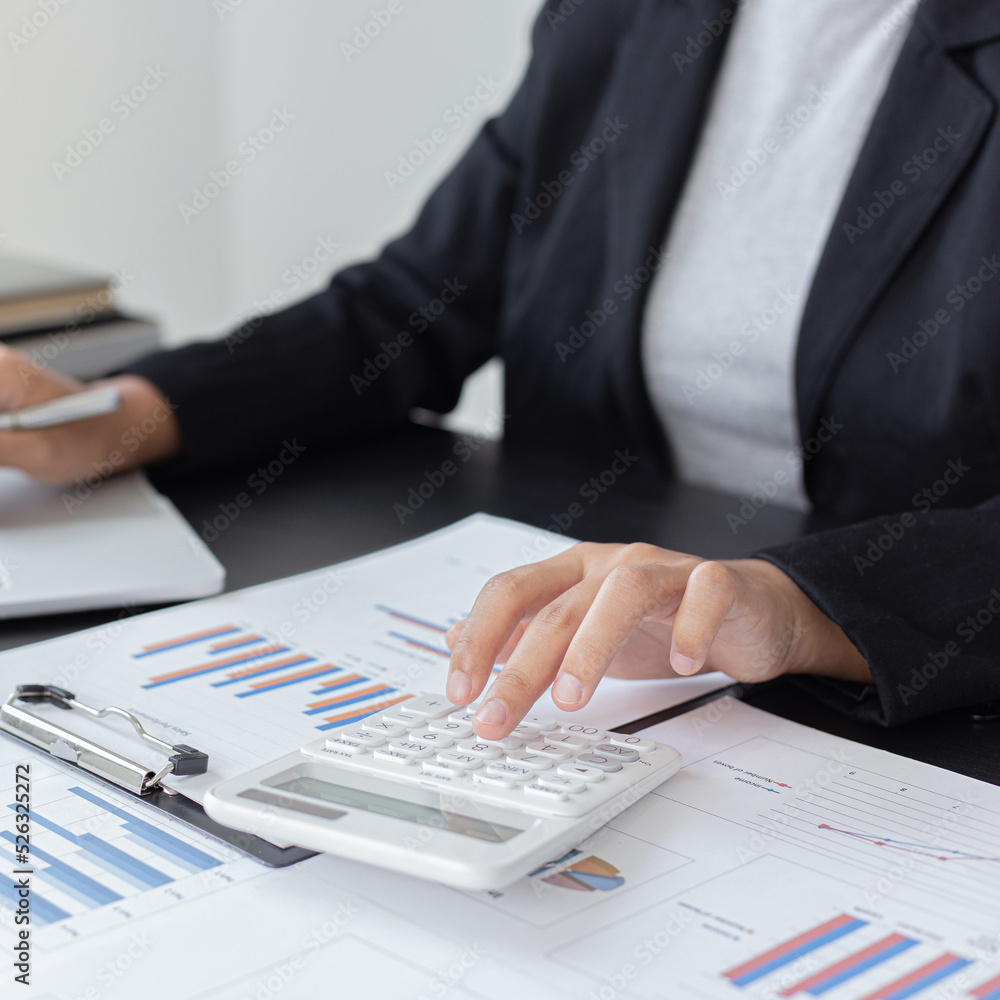 Accounting businessmen are calculating income-expenditure and analyzing real estate investment data, Financial and tax systems concept. Accounting businessmen are calculating income-expenditure and analyzing real estate investment data, Financial and tax systems concept.