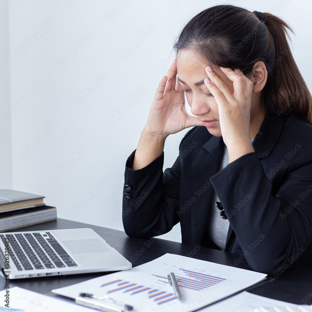 She is stressed due to the economic downturn causing migraine headaches, Financial accountants work on the analysis and summary of company revenue in real estate, Hard work and overtime work concept. She is stressed due to the economic downturn causing migraine headaches, Financial accountants work on the analysis and summary of company revenue in real estate, Hard work and overtime work concept.