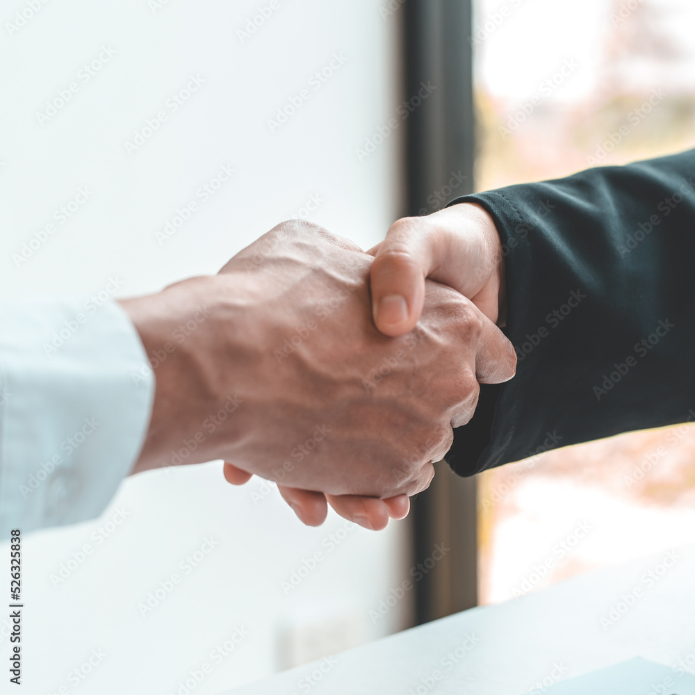 Obraz premium Financial accountants and marketers shaking hand to congratulate the double-digit real estate performance, Meetings and hand shake concept...