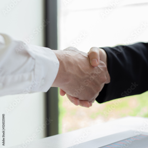 Financial accountants and marketers shaking hand to congratulate the double-digit real estate performance, Meetings and hand shake concept...