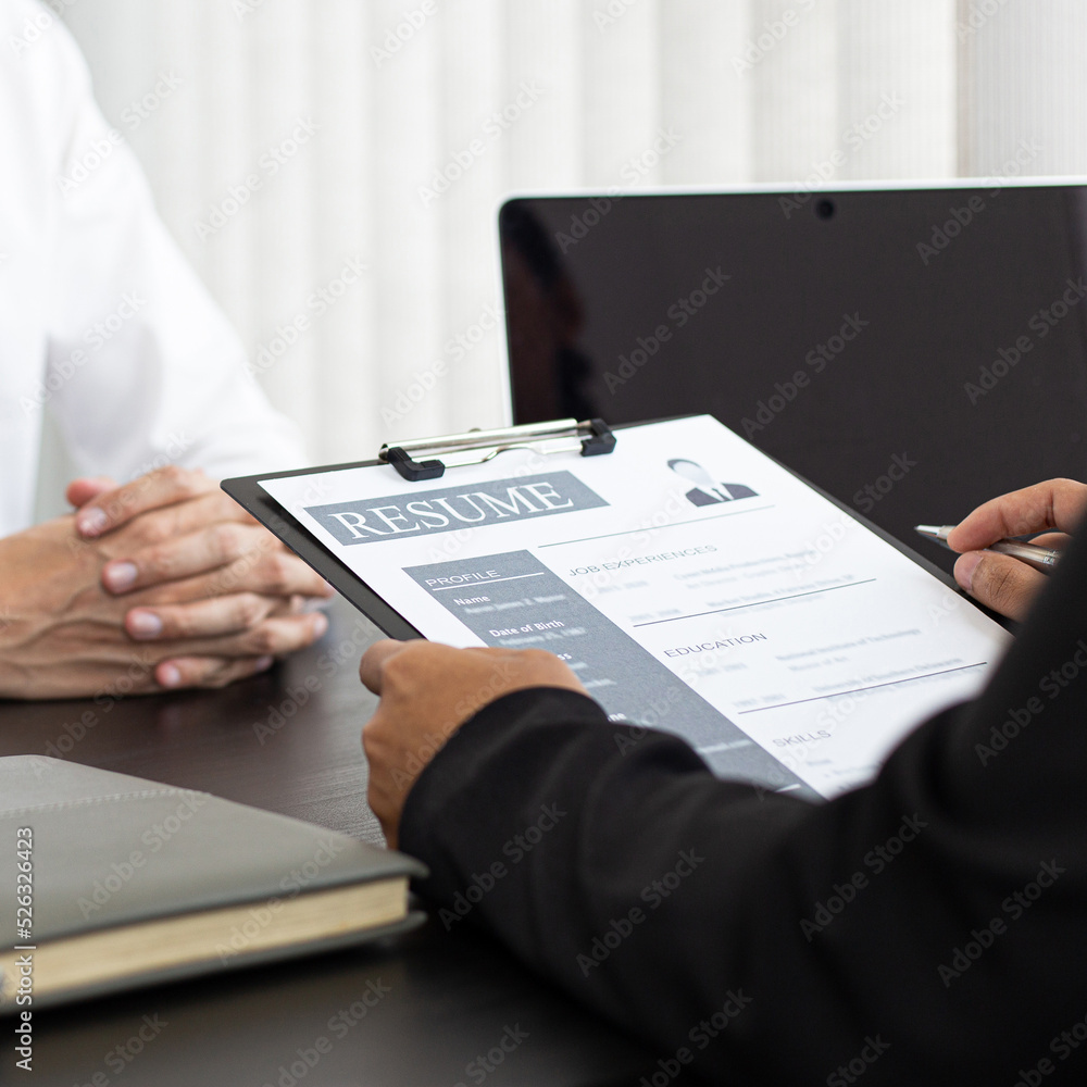 HR head is reading the resume and information about the candidate's history, Field employers are interviewing job applicants and negotiating agreements, Recruitment and job applications concept. HR head is reading the resume and information about the candidate's history, Field employers are interviewing job applicants and negotiating agreements, Recruitment and job applications concept.